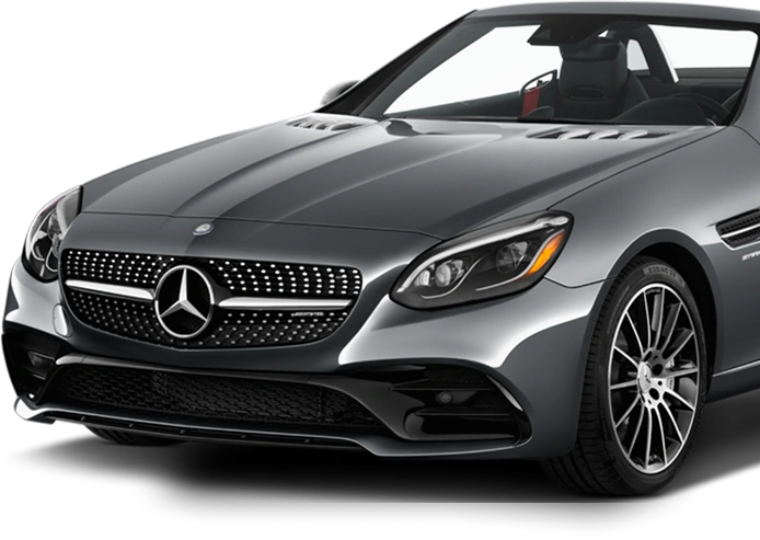 Front angle view of a sleek metallic gray Mercedes-Benz convertible sports car, featuring a diamond-pattern grille with the iconic star emblem, LED headlights, and multi-spoke alloy wheels.