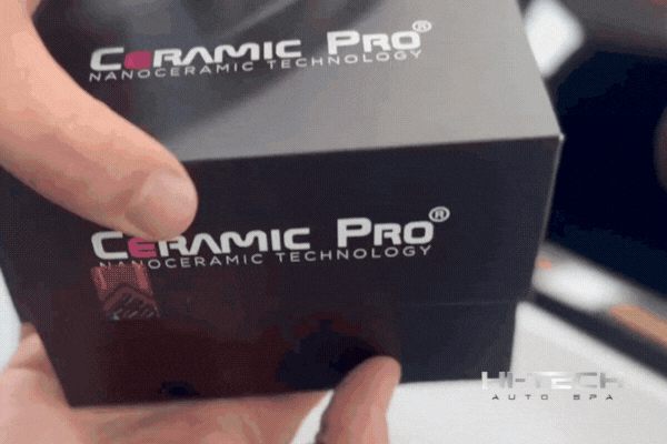 Close-up of a Hi-Tech Auto Spa technician holding a Ceramic Pro nanoceramic technology kit, representing the professional-grade products used for expert ceramic coating applications.